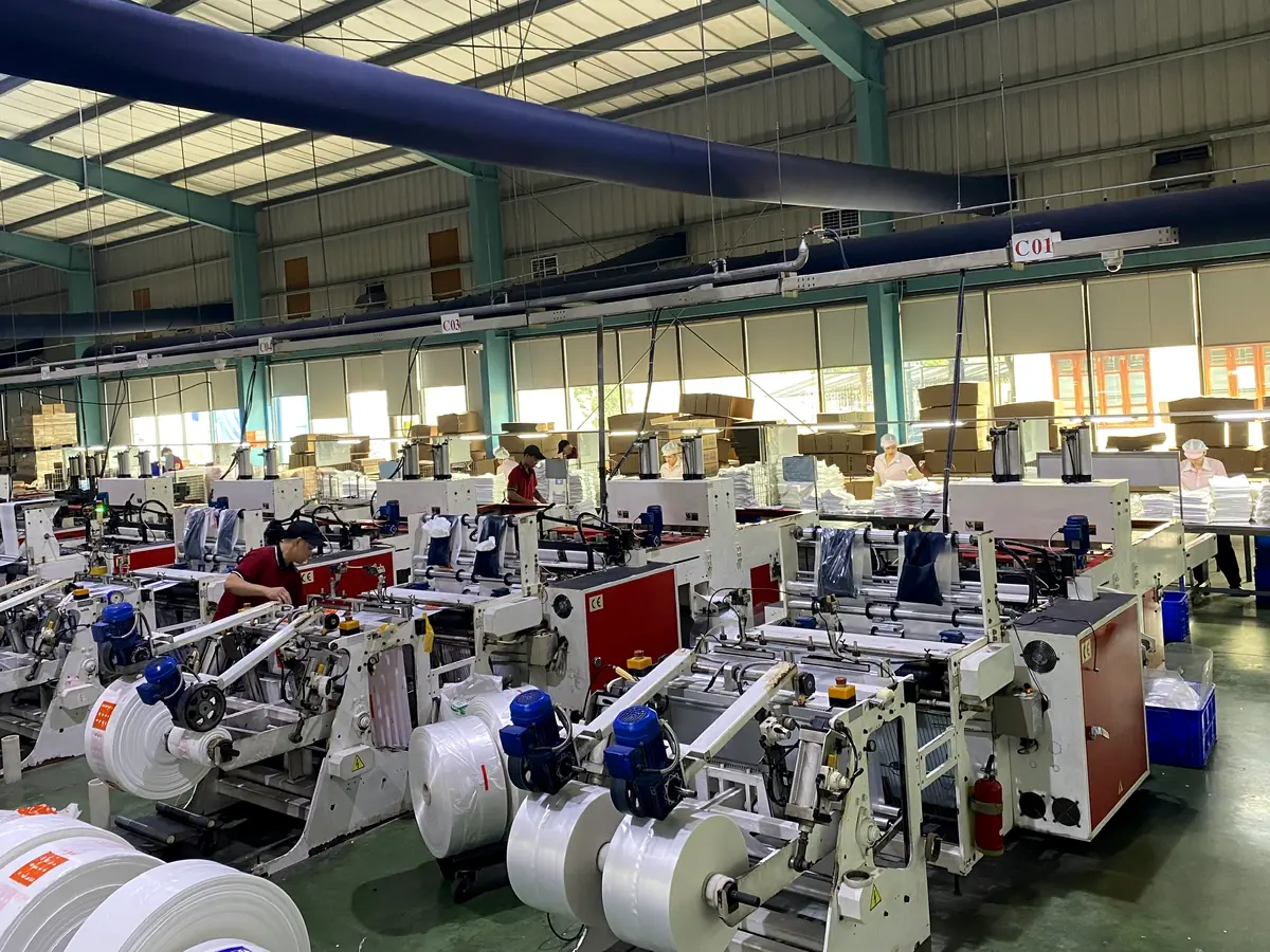 Bag-making hall with cutting and sealing machines at Bupa Plastic
