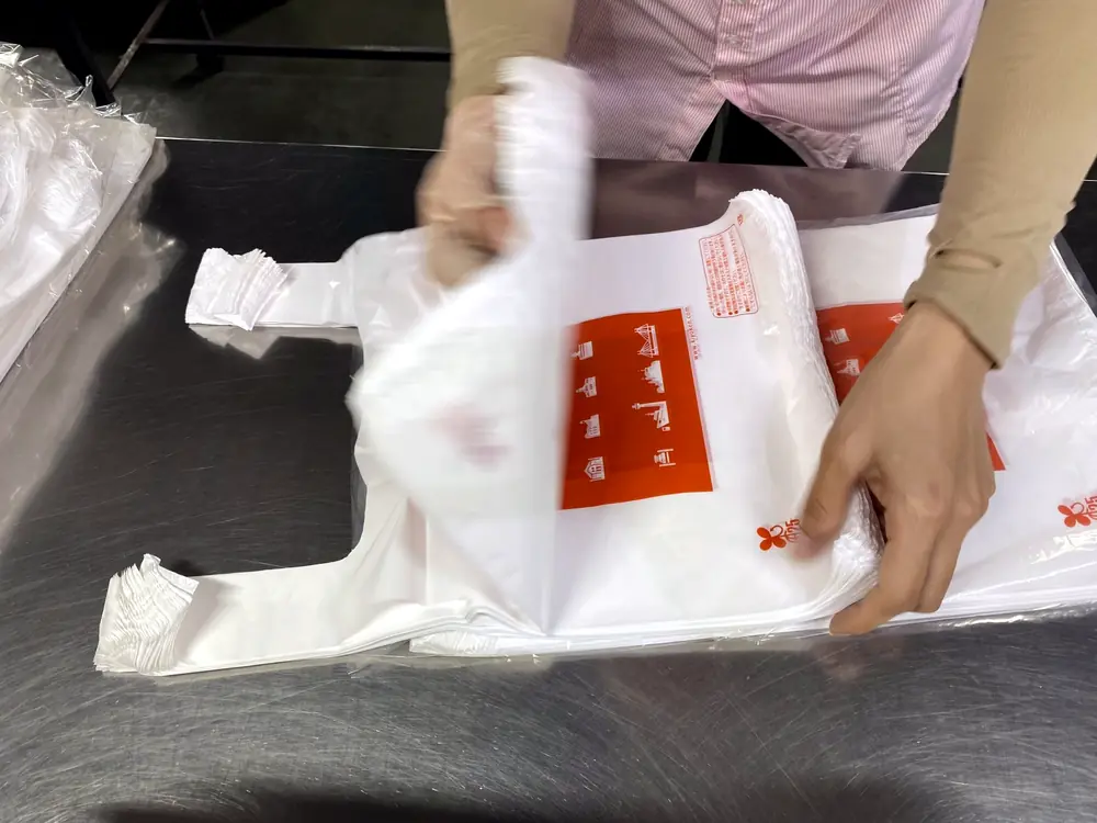 Inspector checking a printed T-shirt bag